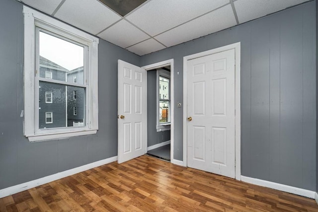 interior space featuring hardwood / wood-style floors and a drop ceiling