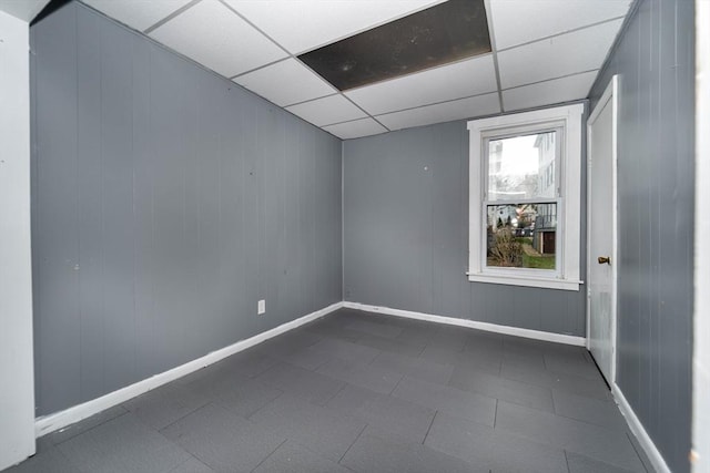 unfurnished room with a drop ceiling