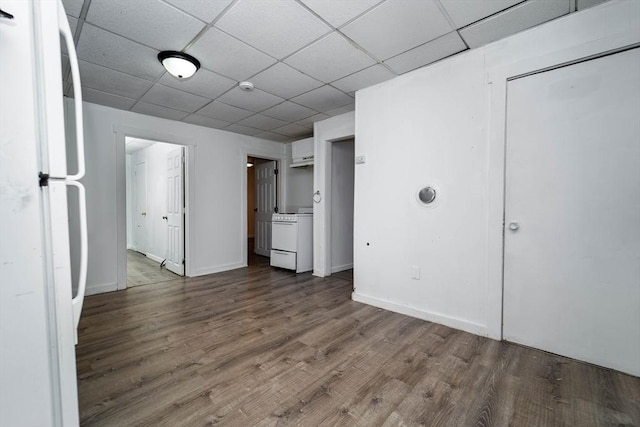 interior space with a paneled ceiling and dark wood-type flooring