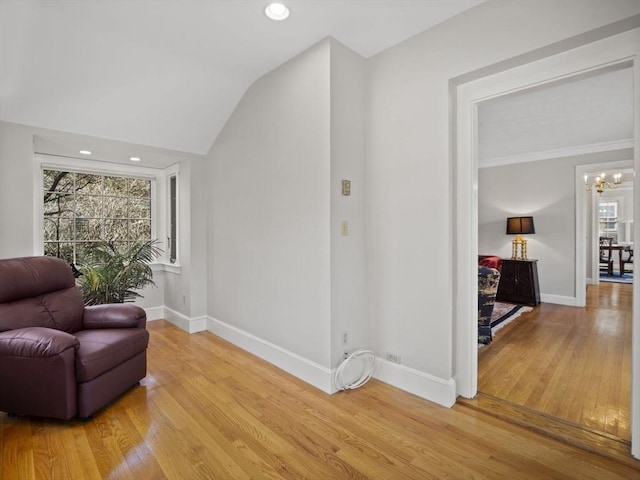 living area featuring recessed lighting, a chandelier, baseboards, and light wood-style flooring