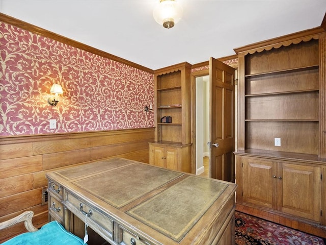 office area featuring wallpapered walls, crown molding, wooden walls, and wainscoting