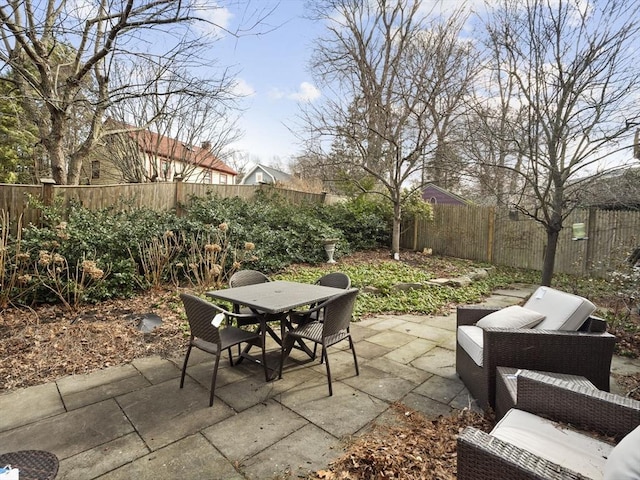 view of patio with outdoor dining area and a fenced backyard