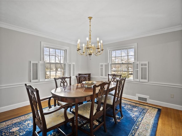 dining space featuring a wealth of natural light, visible vents, wood-type flooring, and baseboards