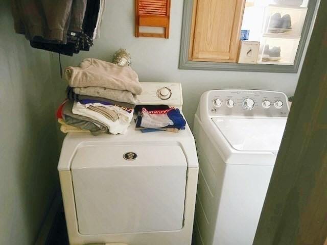 laundry area featuring washer and dryer and cabinets