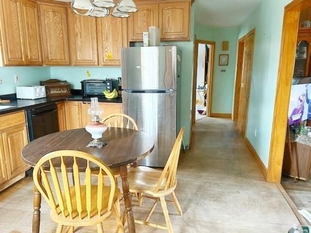 kitchen with stainless steel fridge and black dishwasher