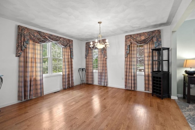 5 Campbell Rd, Middleton, MA 01949 - unfurnished dining area with a chandelier, wood finished floors, and baseboards