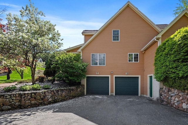 5 Campbell Rd, Middleton, MA 01949 - view of side of home featuring an attached garage and asphalt driveway