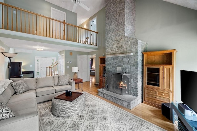 5 Campbell Rd, Middleton, MA 01949 - living area with a high ceiling, wood finished floors, a stone fireplace, stairway, and a ceiling fan