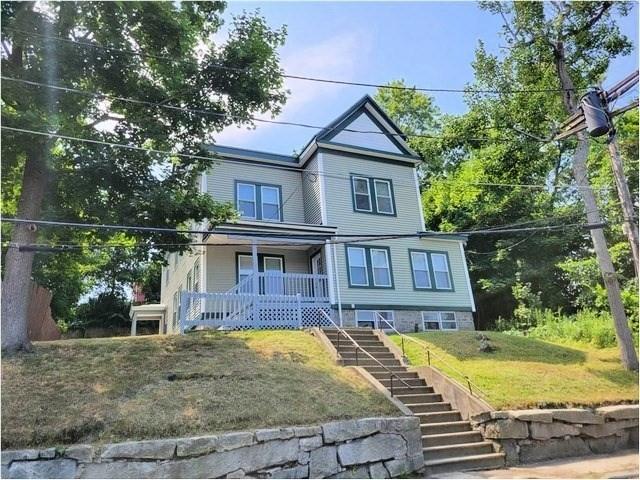 80 Fairmount St, Fitchburg, MA 01420 - view of front facade with stairs, covered porch, and a front yard