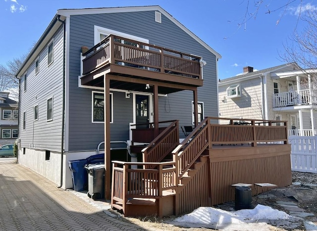 rear view of property featuring a deck