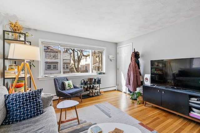 living room with wood finished floors and baseboard heating