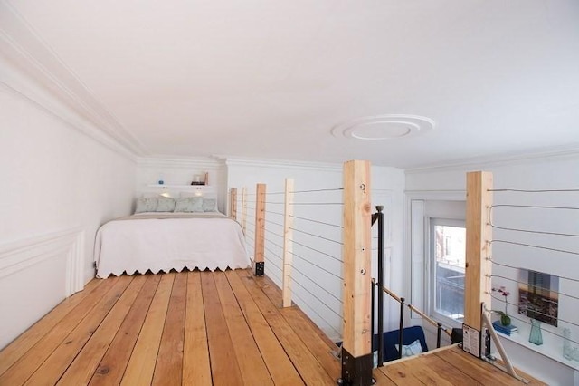 unfurnished bedroom featuring ornamental molding and light hardwood / wood-style floors