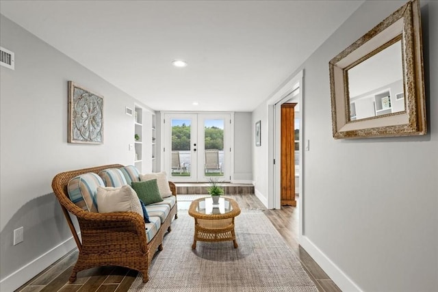 166 Klondike Rd, Dudley, MA 01571 - sitting room with french doors, wood finished floors, baseboards, and recessed lighting