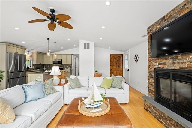 166 Klondike Rd, Dudley, MA 01571 - living room with lofted ceiling, light wood-style floors, a ceiling fan, a fireplace, and recessed lighting