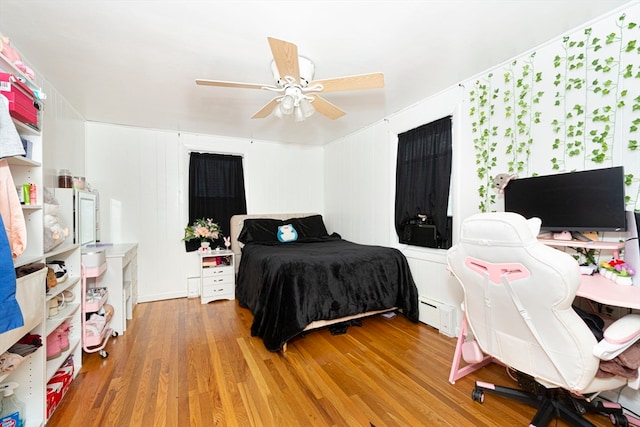 bedroom with wood-type flooring and ceiling fan