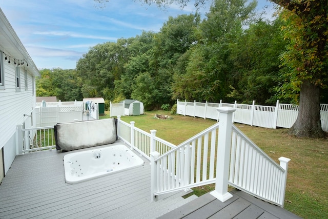 wooden terrace with a yard and a storage unit