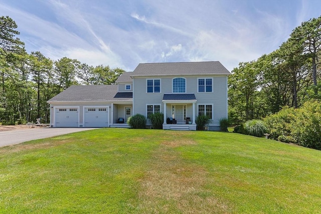15 Littlefield Pond Rd, Harwich, MA 02645 - colonial-style house featuring an attached garage, driveway, and a front yard