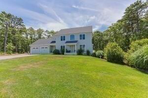 15 Littlefield Pond Rd, Harwich, MA 02645 - colonial home with a garage, driveway, and a front yard