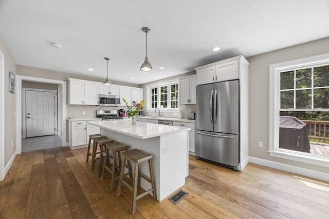 15 Littlefield Pond Rd, Harwich, MA 02645 - kitchen featuring stainless steel appliances, light wood-type flooring, light countertops, white cabinets, and recessed lighting