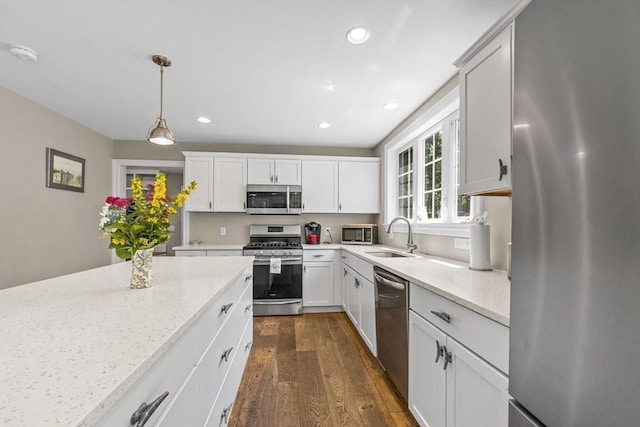 15 Littlefield Pond Rd, Harwich, MA 02645 - kitchen with stainless steel appliances, dark wood-style flooring, recessed lighting, light stone counters, and hanging light fixtures