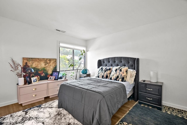 bedroom with dark hardwood / wood-style floors