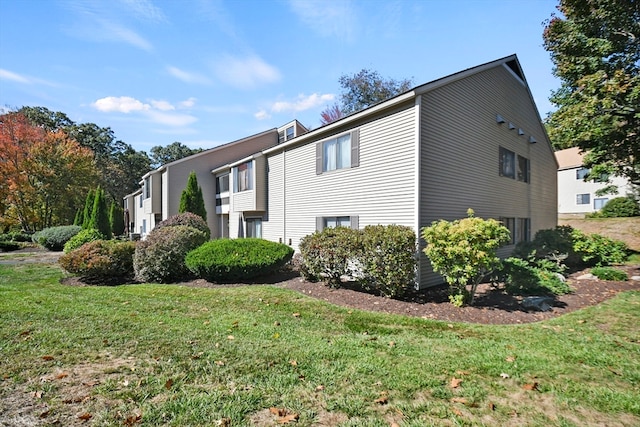 view of side of property with a yard