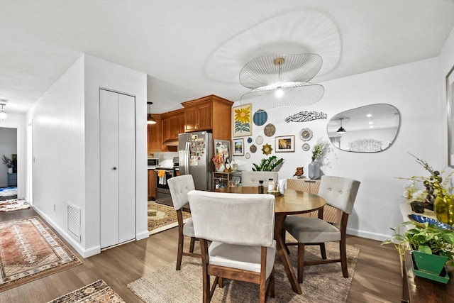 dining area with dark hardwood / wood-style floors