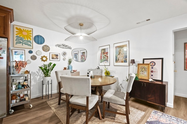 dining room with wood-type flooring