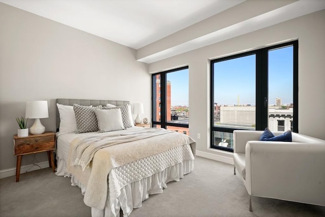 bedroom featuring baseboards and light carpet