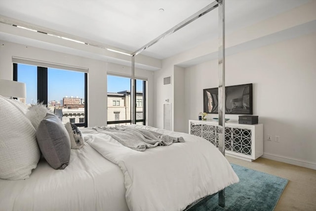 bedroom featuring light colored carpet, baseboards, and access to exterior