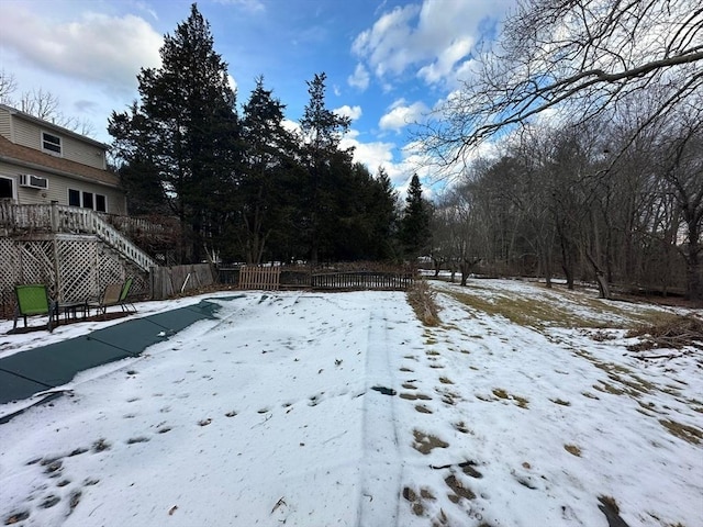 yard covered in snow with a wooden deck