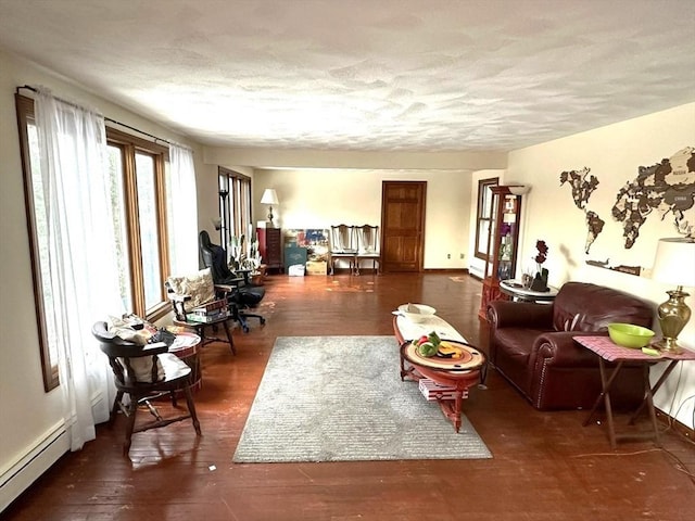 living room with a baseboard radiator, dark hardwood / wood-style flooring, and a textured ceiling