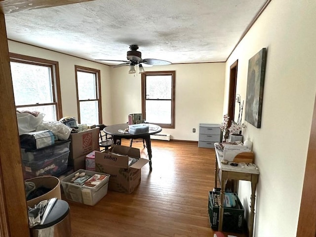 sitting room featuring hardwood / wood-style floors, a textured ceiling, a healthy amount of sunlight, and ceiling fan