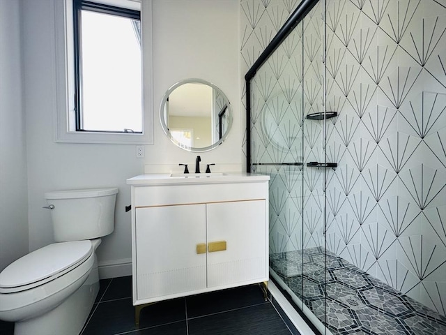 bathroom with tile patterned flooring, vanity, toilet, and a shower