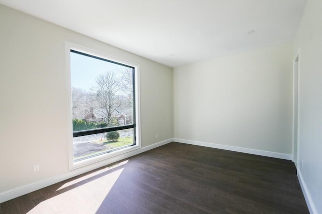 unfurnished room with dark hardwood / wood-style floors