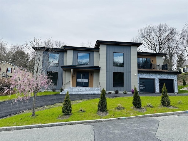 view of front of property with a garage and a front lawn