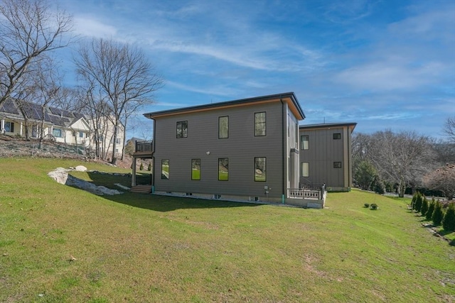 rear view of property with a yard