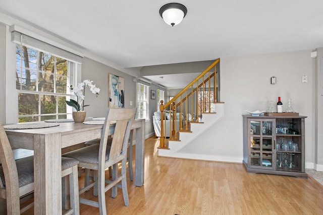 19 Wallis St Unit 4, Beverly, MA 01915 - dining space with wood finished floors, healthy amount of natural light, baseboards, and stairs