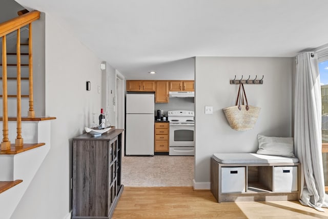 19 Wallis St Unit 4, Beverly, MA 01915 - kitchen with white appliances, under cabinet range hood, light wood finished floors, recessed lighting, and dark countertops