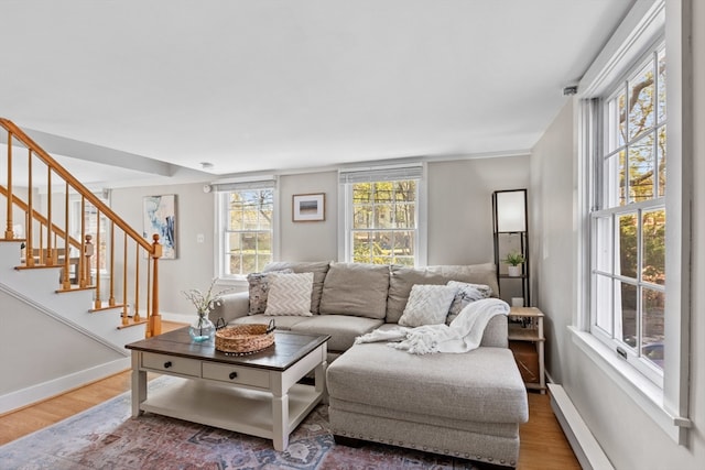 19 Wallis St Unit 4, Beverly, MA 01915 - living room with wood finished floors, stairway, baseboards, and a baseboard heating unit
