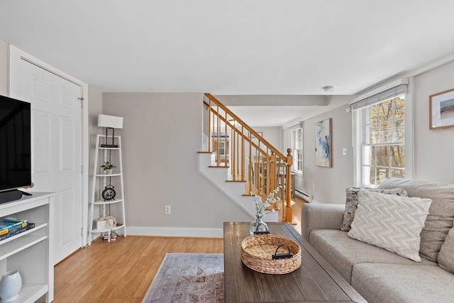 19 Wallis St Unit 4, Beverly, MA 01915 - living area featuring a baseboard heating unit, light wood-style floors, stairway, and baseboards