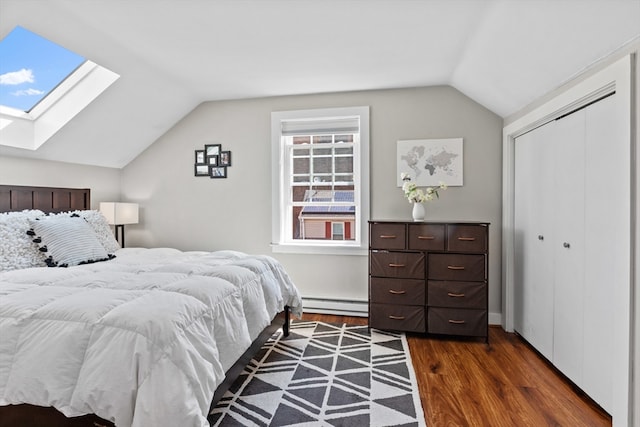 19 Wallis St Unit 4, Beverly, MA 01915 - bedroom with lofted ceiling, a skylight, a baseboard radiator, dark wood-type flooring, and a closet