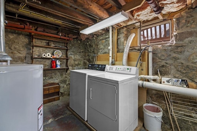 washroom featuring water heater and washing machine and clothes dryer