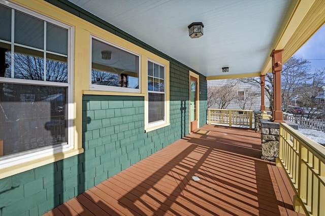 snow covered deck with covered porch