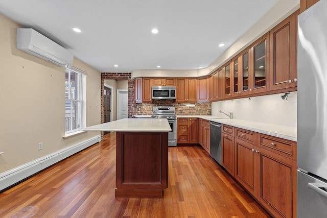 31 Millmont St Unit 1, Boston, MA 02119 - kitchen featuring glass insert cabinets, light countertops, a wall unit AC, light wood-style flooring, and appliances with stainless steel finishes