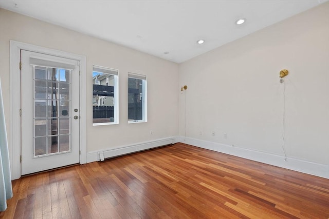 31 Millmont St Unit 1, Boston, MA 02119 - empty room featuring wood-type flooring, a baseboard radiator, baseboards, and recessed lighting