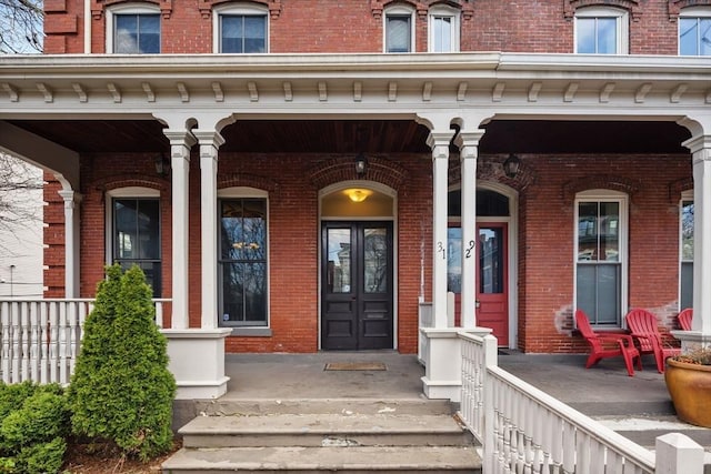 31 Millmont St Unit 1, Boston, MA 02119 - doorway to property with a porch, french doors, and brick siding