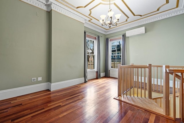 31 Millmont St Unit 1, Boston, MA 02119 - unfurnished room featuring ornamental molding, wood finished floors, baseboards, a wall unit AC, and a notable chandelier