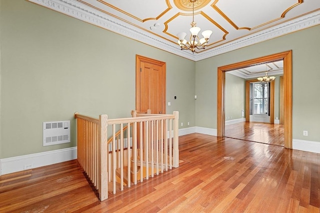 31 Millmont St Unit 1, Boston, MA 02119 - empty room featuring heating unit, wood finished floors, baseboards, an inviting chandelier, and ornamental molding