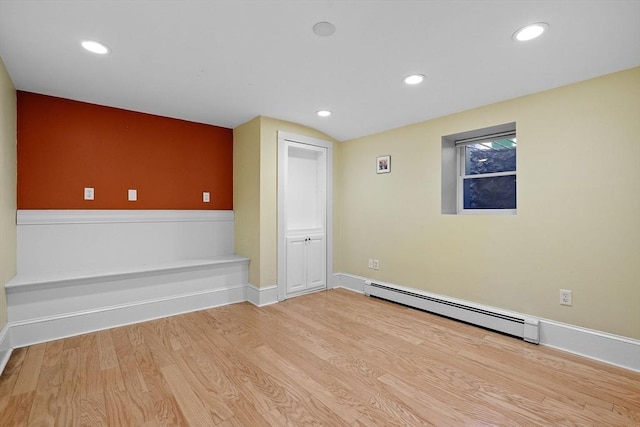 31 Millmont St Unit 1, Boston, MA 02119 - empty room with wood finished floors, recessed lighting, baseboards, and a baseboard heating unit